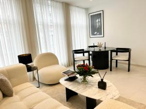 a living room with a couch and a table and chairs at luxury in Mons