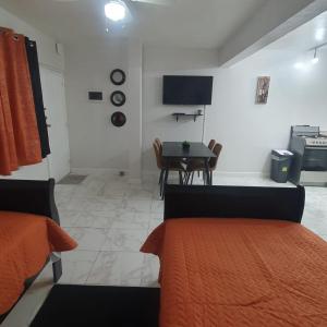 a room with a kitchen and a table with a bed at The Castle in Philipsburg