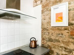 a tea kettle sitting on a table in a kitchen at Lovely Apartment near Piazza della Signoria in Florence