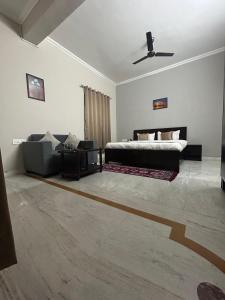 um quarto com uma cama e um sofá em RAJ RESIDENCY em Gurgaon