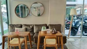 a living room with a couch and tables and mirrors at Elio Sukhumvit 64: Chic Space in Bangkok +27 photos