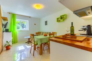 a kitchen and dining room with a table and chairs at Apartments Filipovic, 3 min walk to the beach in Split