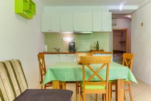 a kitchen with a table with a green table cloth at Apartments Filipovic, 3 min walk to the beach in Split