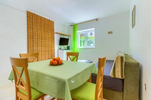 a dining room and living room with a table and chairs at Apartments Filipovic, 3 min walk to the beach in Split