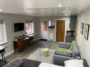 a living room with a couch and a table at SPALDING - Self Contained Studio Double - An extra single bed can be provided in Lincolnshire
