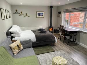 a bedroom with a bed and a couch and a desk at SPALDING - Self Contained Studio Double - An extra single bed can be provided in Lincolnshire