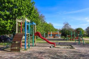 a playground with a slide in a park at Guests house Provence in Kavarna