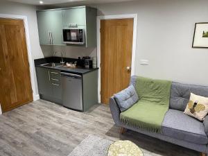a living room with a couch and a kitchen at SPALDING - Self Contained Studio Double - An extra single bed can be provided in Lincolnshire