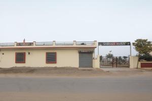 a building with a sign on the top of it at Nidhivan Guest House in Kishangarh