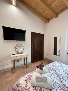 a bedroom with a bed and a flat screen tv at Guest House il Il Podestà in Garbagna