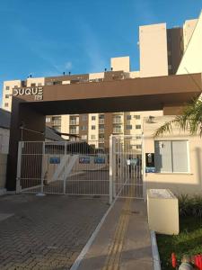 a gate in front of a building with a bridge at Loft bem localizado no Fragata in Pelotas