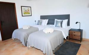 a bedroom with two beds with white sheets at La Pina Verde in Estepona