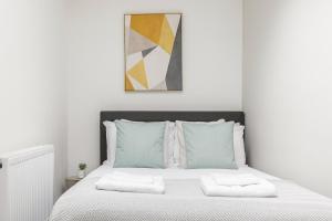 Ένα ή περισσότερα κρεβάτια σε δωμάτιο στο The Peckham Apartments