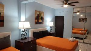 a bedroom with two beds and a mirror at Remodeled & Very Cozy sleeps 12 near Casa Bacardi, Center Unit in Catano