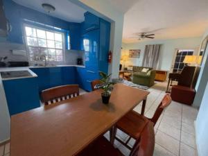 a kitchen and living room with a wooden table and chairs at Remodeled & Very Cozy sleeps 12 near Casa Bacardi, Center Unit in Catano