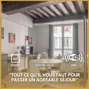 a living room with a table and a window at Somptueux studio Hyper Centre avec WIFI in Orléans