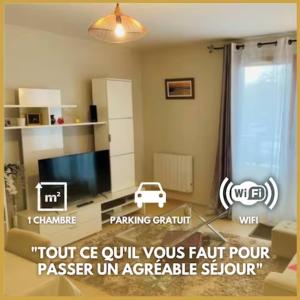 a living room with a tv and a couch at Le Micy - joli T2 + Parking in Orléans