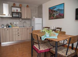 a kitchen and dining room with a table and chairs at DonPeppeHouse in Minori