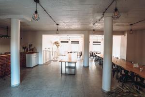 a dining room with a long table and chairs at Kalwados in Radzymin