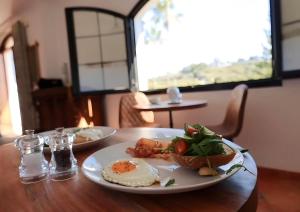 a wooden table with two plates of food on it at La Pina Verde in Estepona