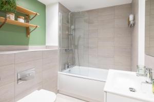 a bathroom with a shower and a toilet and a sink at Beautiful apartment in city centre in Southampton