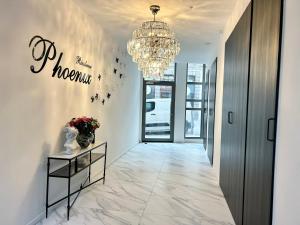 a hallway with a chandelier and a hallway with a table at luxury in Mons
