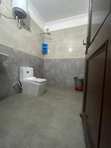 a bathroom with a toilet and a sink at RAJ RESIDENCY in Gurgaon