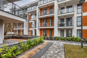 an apartment building with a courtyard with plants at Pobierowo Beach Baltic Apartments by Renters in Pobierowo