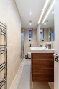 a bathroom with a sink and a toilet at The St John's Wood Apartment in London