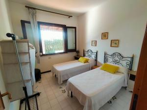 a bedroom with two beds and a window at Casa&Mare Mazara del Vallo in Granitola