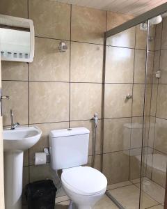 a bathroom with a toilet and a sink and a shower at Casa Silveira NORONHA in Fernando de Noronha
