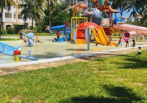 a park with a playground with a water slide at Haradali Suites 2 Bedroom Beach Apartment - Sultan Palace Beach Resort in Kilifi