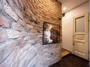 a television hanging on a brick wall at Kauno Senamiestis in Kaunas +3 photos