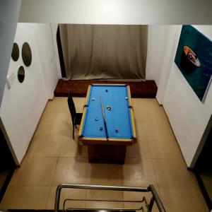 a ping pong table in the middle of a room at ReUnion Villa ll Swimming Pool ll Snooker ll AC ll BBQ ll 3BHK in Lonavala