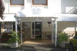 a white awning in front of a building at Garabit Hotel in Garabit