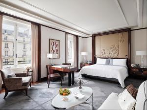 a hotel room with a bed and a desk at Hotel The Peninsula Paris in Paris