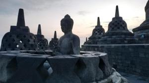 a statue in front of a temple at Genthong Homestay in Borobudur