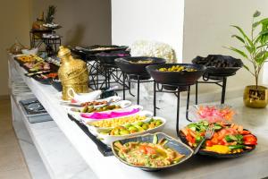 a buffet with many plates of food on a table at New MerryLand Hotel in Amman