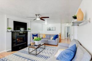 a living room with a couch and a fireplace at Right off i215 Close to Ski Resorts and Mountains in Cottonwood Heights