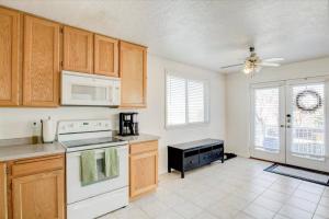 a kitchen with white appliances and wooden cabinets at Right off i215 Close to Ski Resorts and Mountains in Cottonwood Heights