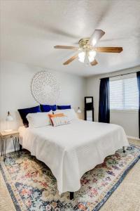 a bedroom with a white bed and a ceiling fan at Right off i215 Close to Ski Resorts and Mountains in Cottonwood Heights