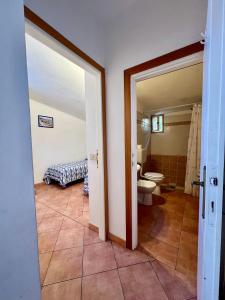a bathroom with a toilet and a sink at Case Vacanze Maestrale in Fetovaia