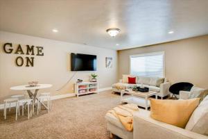 a living room with a couch and a table at Central LocationGarage Large andFenced Backyard in Orem