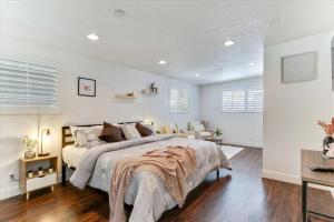 a white bedroom with a large bed and a couch at King Bed Modern Living Room Cozy Backdoor Patio in Salt Lake City