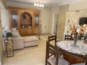 a living room with a table and a couch at Nile view in Cairo