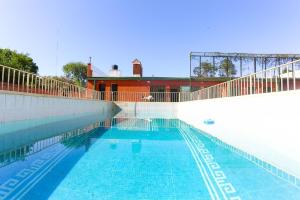 a large swimming pool with a fence around it at Amplia Quinta Familiar en Sauce Viejo in Sauce Viejo