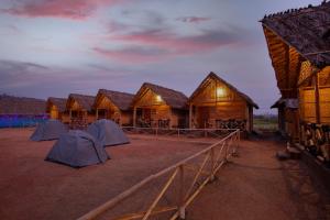 a row of lodges in the desert at night at Hampi Social Resort in Hampi