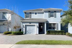 a white house with a garage at Wonderful home close to disney & universal in Kissimmee