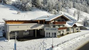 a ski lodge with snow on the ground at Appartement Riepler in Wagrain