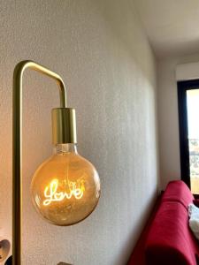 a light bulb with the word love written on it at Charmant T2 au cœur de la ville in Furiani